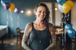 © OPPERMAN - Woman with arm tattoos at her baby shower party before the guests arrive. Generative AI.