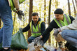 © Oleksii Syrotkin/Stocksy - Teamwork awareness volunteering trash nature unity