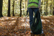© Oleksii Syrotkin/Stocksy - Anonymous eco activist grove awareness tool clean up voluntary