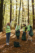 © Oleksii Syrotkin/Stocksy - volunteers photo togetherness charity clean up outdoors