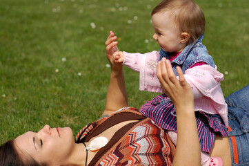 Wall Mural - happy family on green grass