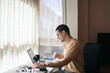 © Pedro Merino/Stocksy - Home office: young man teleworking with laptop at home