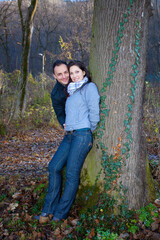 Young couple playing around in the nature - front view.