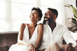 © Trinette Reed - Portrait of mature successful Black couple laughing in luxury home. Generative AI.