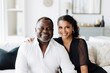 © Trinette Reed - Portrait of happy wealthy mature Black couple in luxury home. Generative AI.