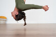 © Bisual Studio/Stocksy - Woman performing aerial yoga pose in studio