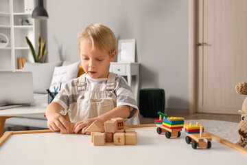 Canvas Print - Cute little boy playing with wooden cubes at home