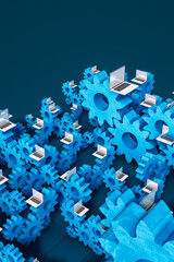 Laptop computers next to cogwheel gears