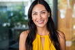 © David Prado/Stocksy - Smiling asian woman portrait wear yellow dress looking at camera