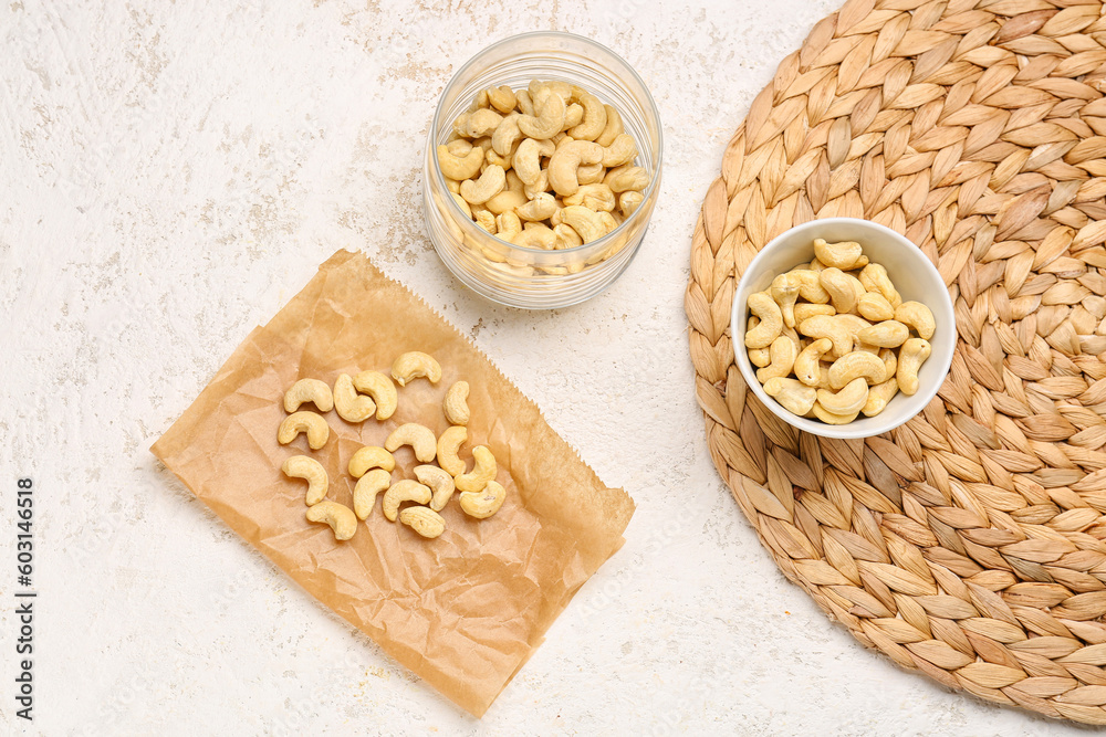 Tasty cashew nuts on light background