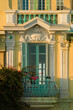 © Sonja Lekovic/Stocksy - stylish yellow and orange building facade with green window shades