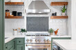 White square tiled kitchen corner surrounded by Kitchen appliances, two shelves, and a book. 