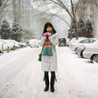 © Yuan Lei/Stocksy - The woman in cotton clothes is in a snowy residential area