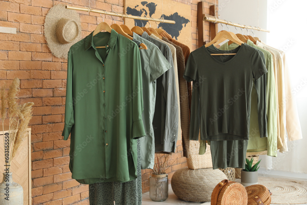 Rack with stylish female clothes in boutique