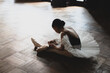 © Yumiko Kinoshita - teenage ballerina tying pointe shoes