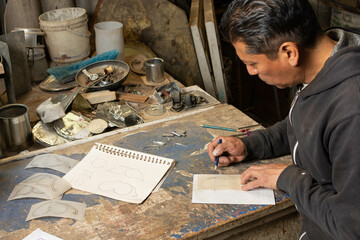 Creating Beauty: Talented Man Drawing a Unique Ironwork Design