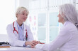 © megaflopp - Doctor holds patient hands during consultation in hospital