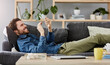 © Viglietti/peopleimages.com - Social networking, man with smartphone on sofa and lying in living room at his home. Connectivity or technology, smile and happy male person with cellphone comfortable on couch playing online game