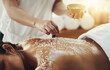 Woman, hands and salt in massage at spa for skincare, exfoliation or body treatment at resort. Hand of masseuse applying salts to back skin for relaxation, therapy or zen in healthy wellness at salon