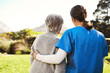 © Chanelle Malambo/peopleimages.com - Senior woman, nurse and hug in healthcare, life insurance or support together in nature. back view of mature female with caregiver in elderly care, medical aid or garden walk at nursing home outdoors