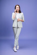 © Timeimage - Full length photo of young Asian businesswoman on background