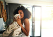 © Stratford/peopleimages.com - Laundry smell, african woman and cleaning chores with happiness and calm in home. Smile, fresh clothes and lens flare with washing of a black female person in a house feeling relax in the morning