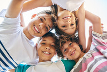 Portrait, Low Angle And A Group Of Happy Siblings Or Huddled Together Or Hug In Solidarity And Smiling Outdoors. Circle, Brothers And Sisters Or Excited Children Play Or Bonding And Face Outside