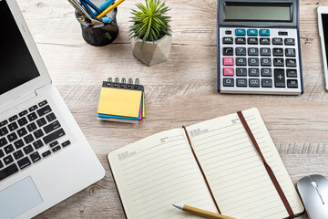 Poster - office desk background with laptop, empty notepad, pen calculator and supplies