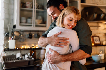 Canvas Print - Lovely multiethnic couple spends quality time together smiling at home. People happiness concept.