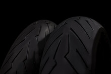 Close-up Image Of Set Of New Racing Road Motorcycle Tyres Over Black Background.