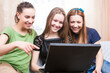 © danmorgan12 - Lifestyle Ideas. Group of Three Young Laughing Caucasian Girlfriends Having Fun With Personal Laptop Computer