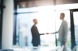 © N Hiraman/peopleimages.com - Business people, handshake and partnership for meeting, hiring or b2b deal agreement at office. Businessman shaking hands in recruiting, teamwork or collaboration with blurred background at workplace