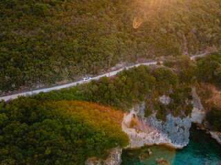 Wall Mural - overhead view of car moving by road next to sea shore