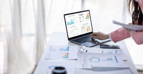 Financial Businesswomen analyze the graph of the company's performance to create profits and growth, Market research reports and income statistics, Financial and Accounting concept.	