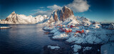 Fototapeta Na ścianę - Hamnoy fishing village on Lofoten Islands, Norway with red rorbu houses in winter. Concept of Travel and holiday on nature, tourist and fishing leisure. Iconic location for landscape photographers