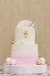 A big beautiful pink and white cake for a baby for baptism