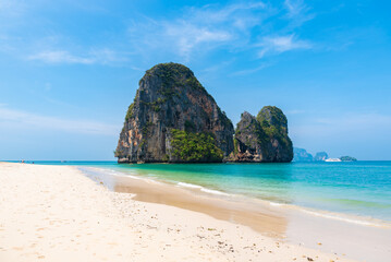 horizontal wide angle photo, phra nang beach in Thailand, paradise, sunny beach, sunbathing and swimming in the sea, blue ocean and sky, relaxation and enjoyment, rock koh rang nok, tourist liner