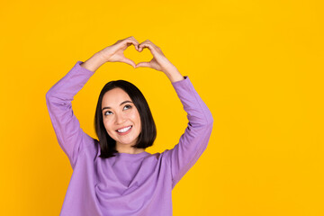 Sticker - Photo of young attractive korean lovely woman show fingers heart sign wear trendy shirt sympathy feelings isolated on yellow color background