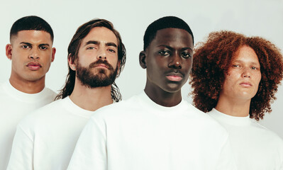 Wall Mural - Group of diverse young men with unique skin types standing in a studio