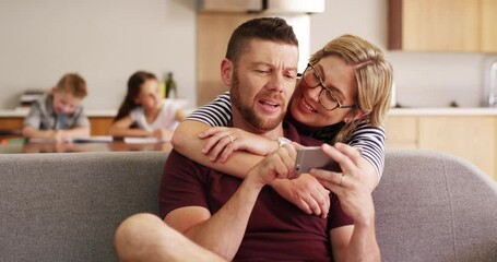 Poster - Phone, social media and a married couple on a sofa in the living room of their home together for bonding. Mobile, happy or love with a man and woman using a mobile for communication in their house