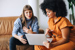 © (JLco) Julia Amaral - Two businesswomen having a discussion while looking at a laptop screen
