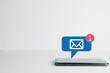 © Pakorn - New Email ,massage,unread email concept.,Smartphone with new e-mail or notification icon on white table over white background with copyspace use for technology idea.