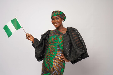 Portrait of gorgeous Nigerian woman waving the national flag