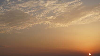 Wall Mural - the beautiful sunset view with the buildings' silhouette and orange color sky as background in the c