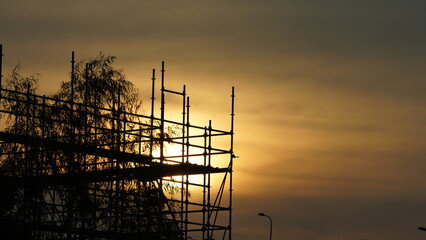 Wall Mural - the beautiful sunset view with the buildings' silhouette and orange color sky as background in the c