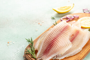 Wall Mural - raw fish fillet white Tilapia on a light background. top view