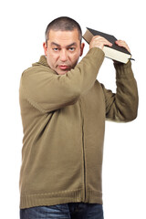 A serious casual man holding a book over white background