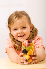 Happy little girl with fruity refreshment - healthy diet concept