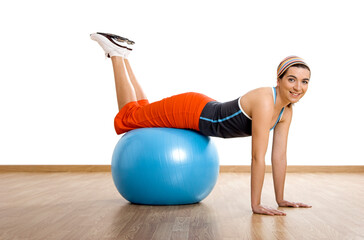 Wall Mural - Beautiful young woman making exercises with a core ball