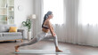 © Prostock-studio - Flexible athletic young woman doing yoga at home